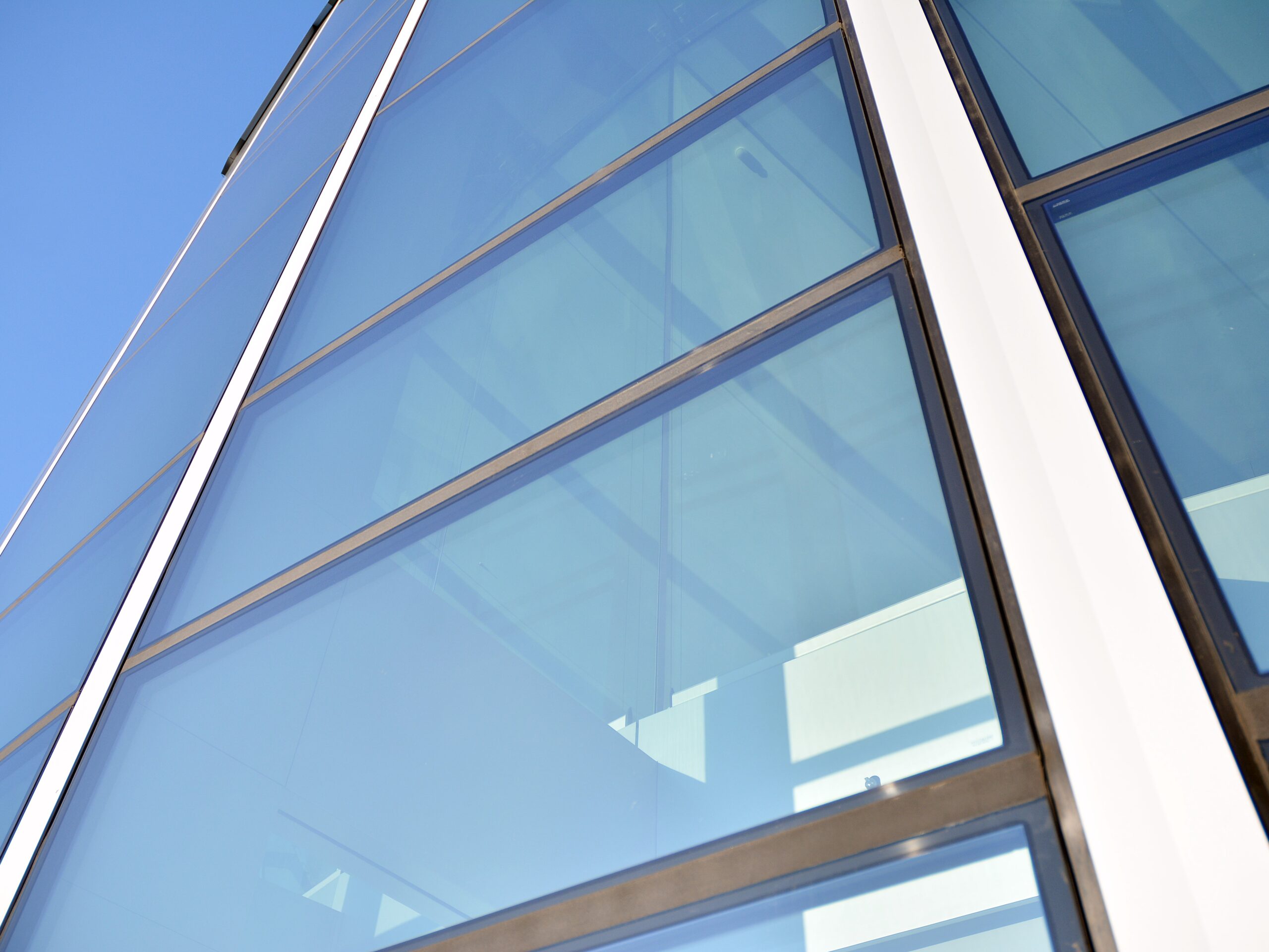 modern-office-building-with-glass-facade-clear-sky-background-transparent-glass