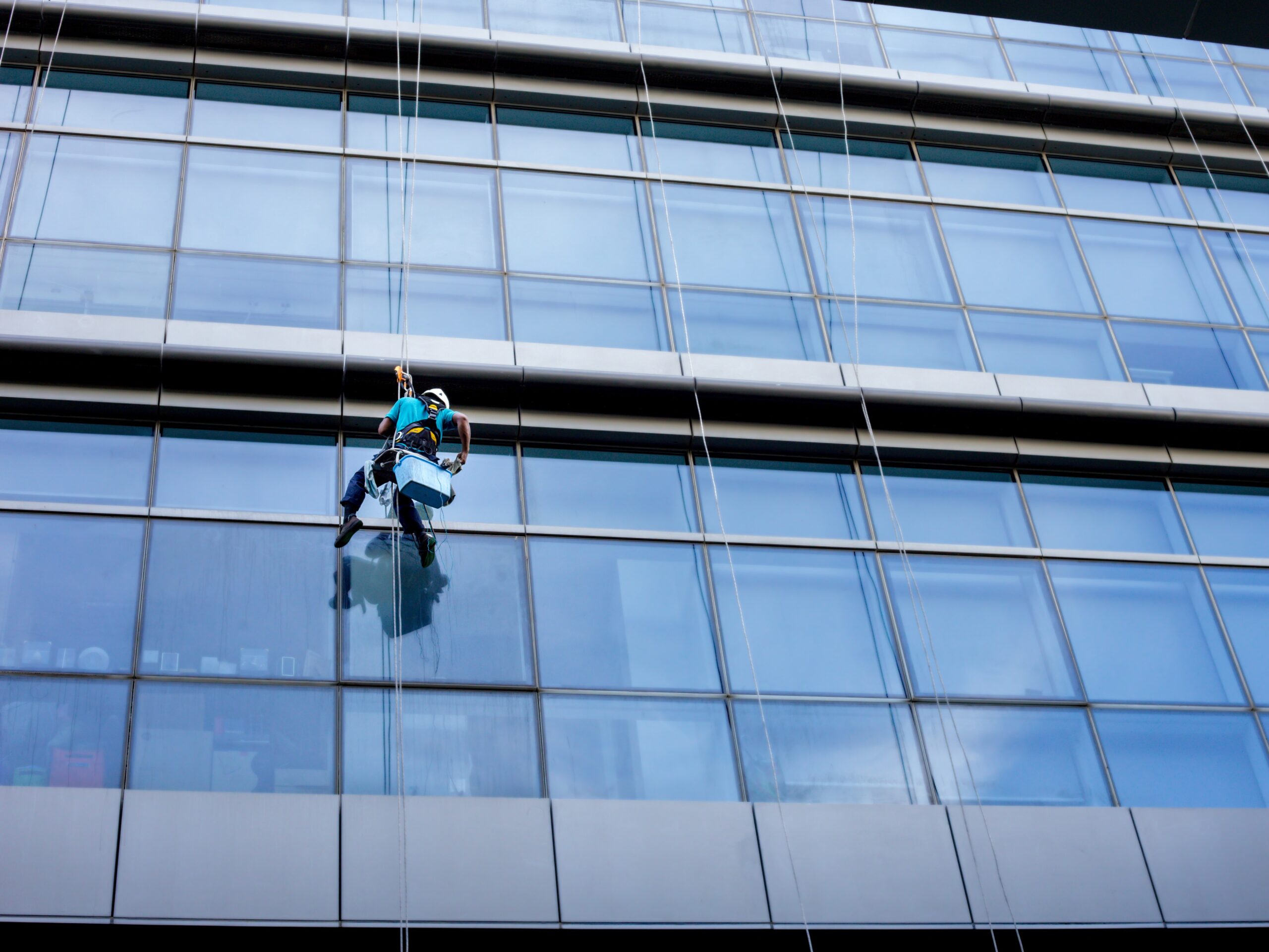 Window cleaner working on a glass.
