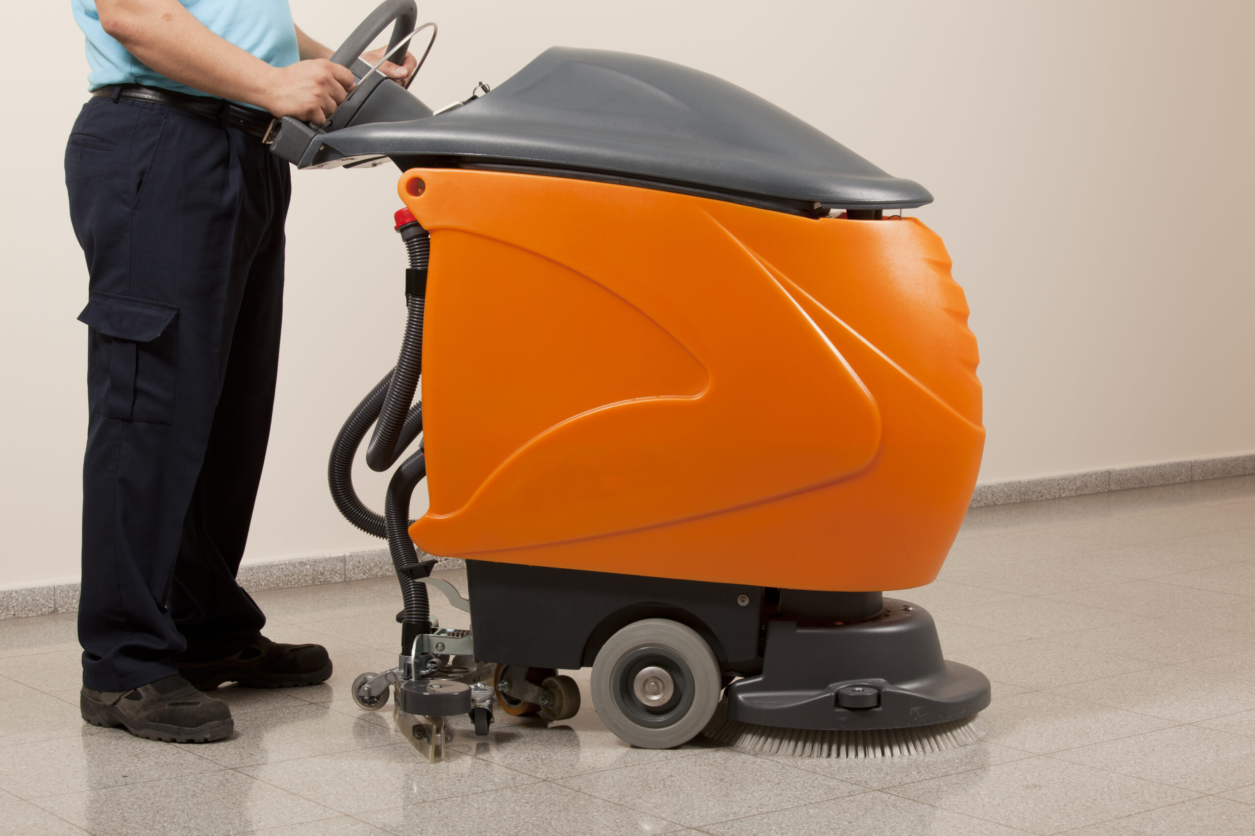 A Man worker cleaning the floor with scrubber machine. image. High quality photo