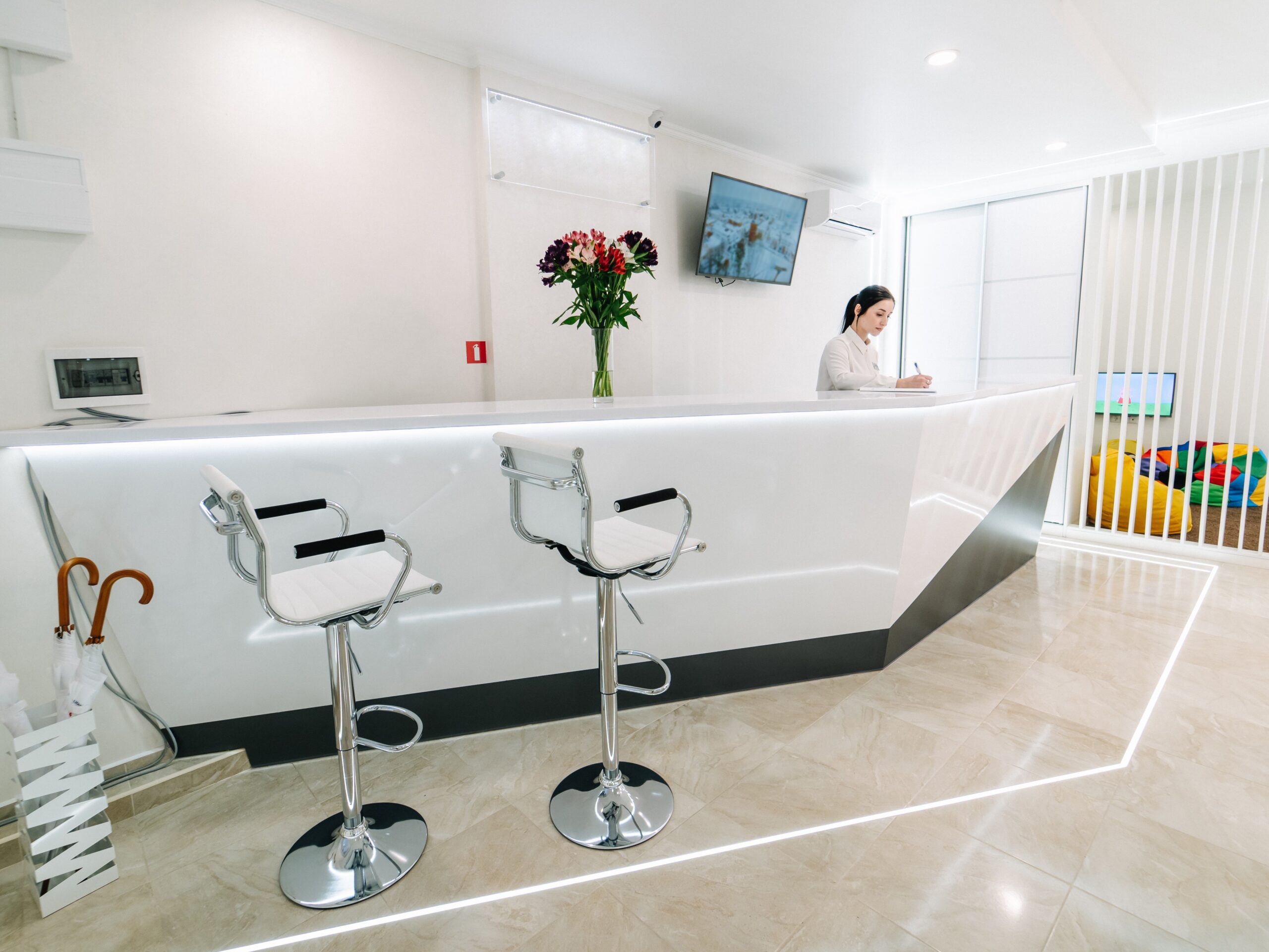 Reception area at the dental clinic. working place is with high chairs in white colors