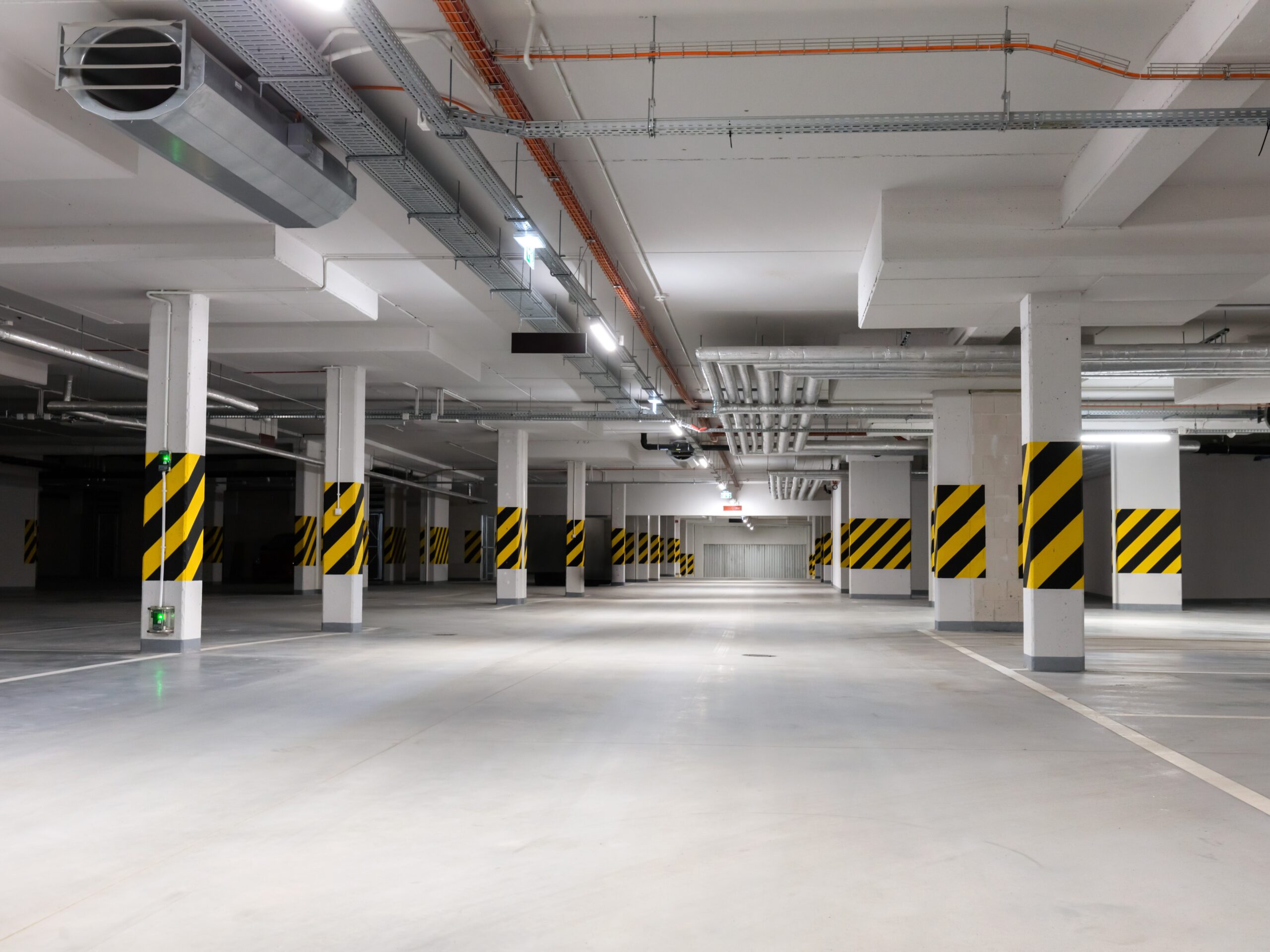 Underground empty parking garage. Modern urban space. Wide angle